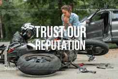 Injured rider near damaged bike and car showing risks of motorcycle accidents in Boise